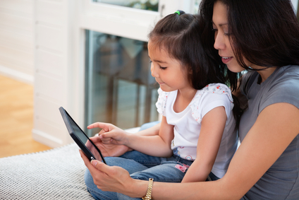 Mother and daughter reading electronic book