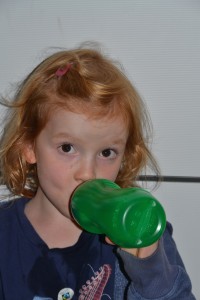 girls drinking from cup