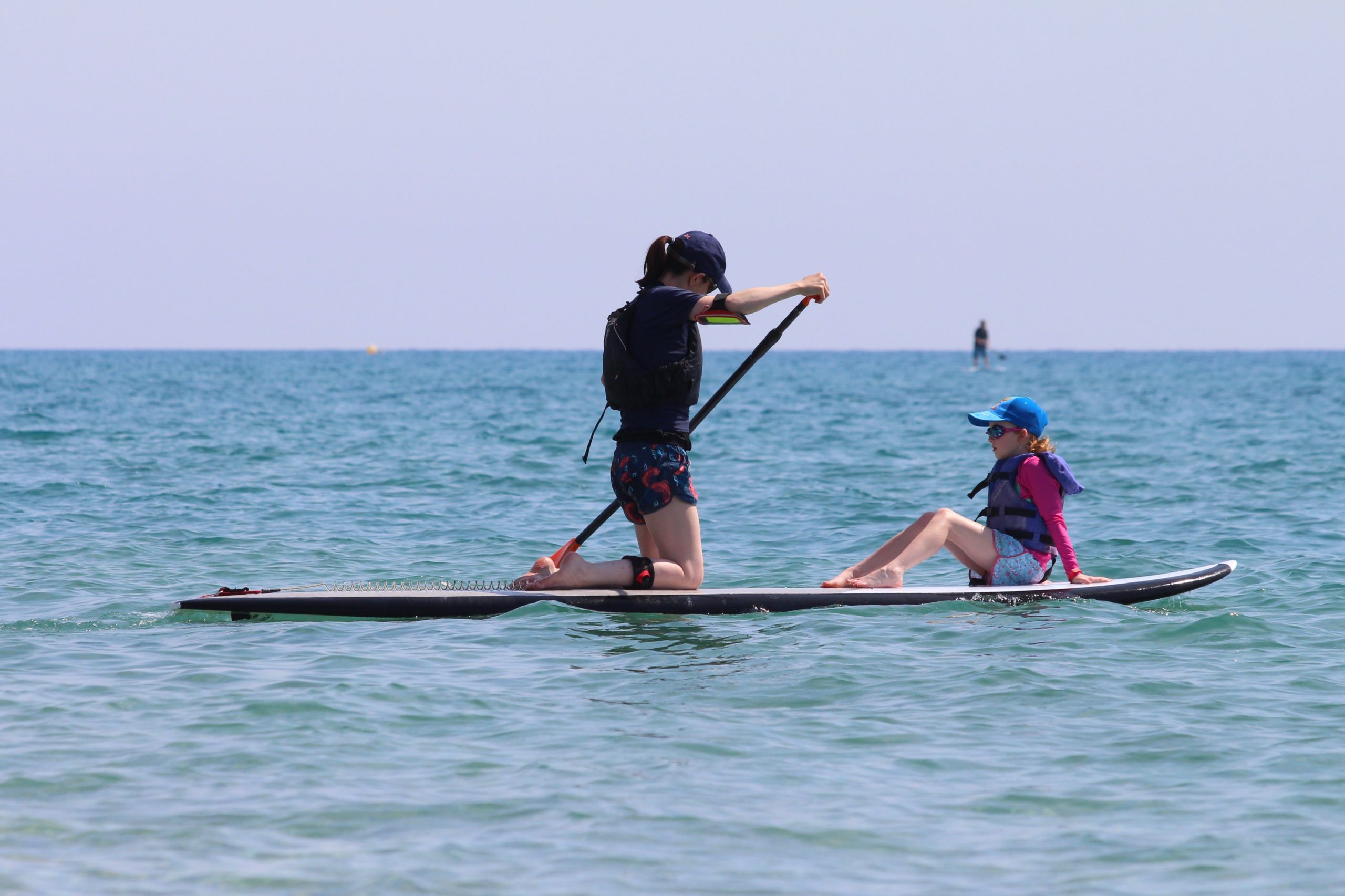 Mum and child paddleboard