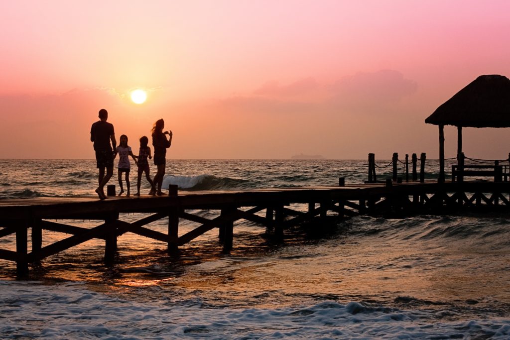Family on a pier at sunset