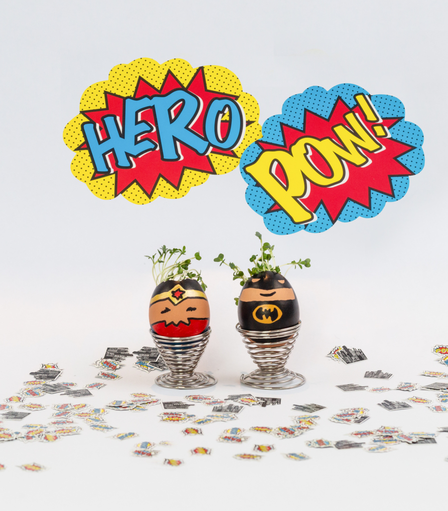 cress grown in eggshells decorated like superheroes