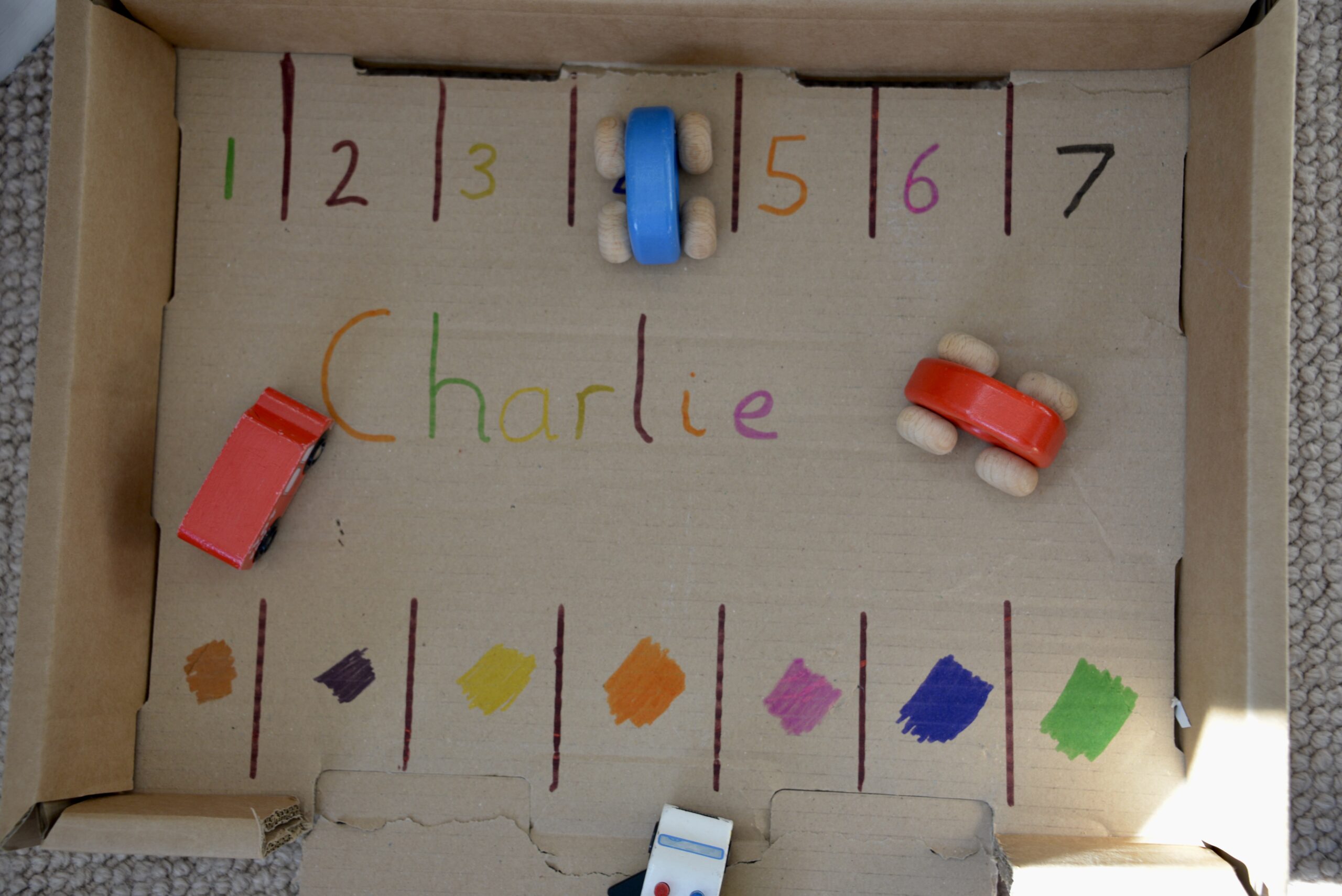 recycled cardboard box car park used to teach numbers and colours