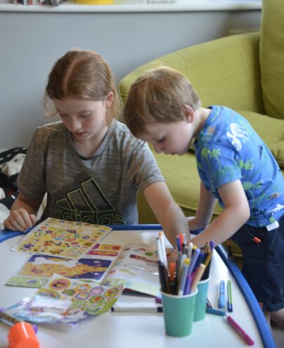 Two children working on the Hey Duggee magazine
