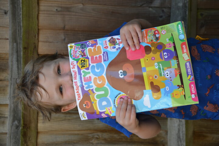 Little boy holding the Hey Duggee Magazine