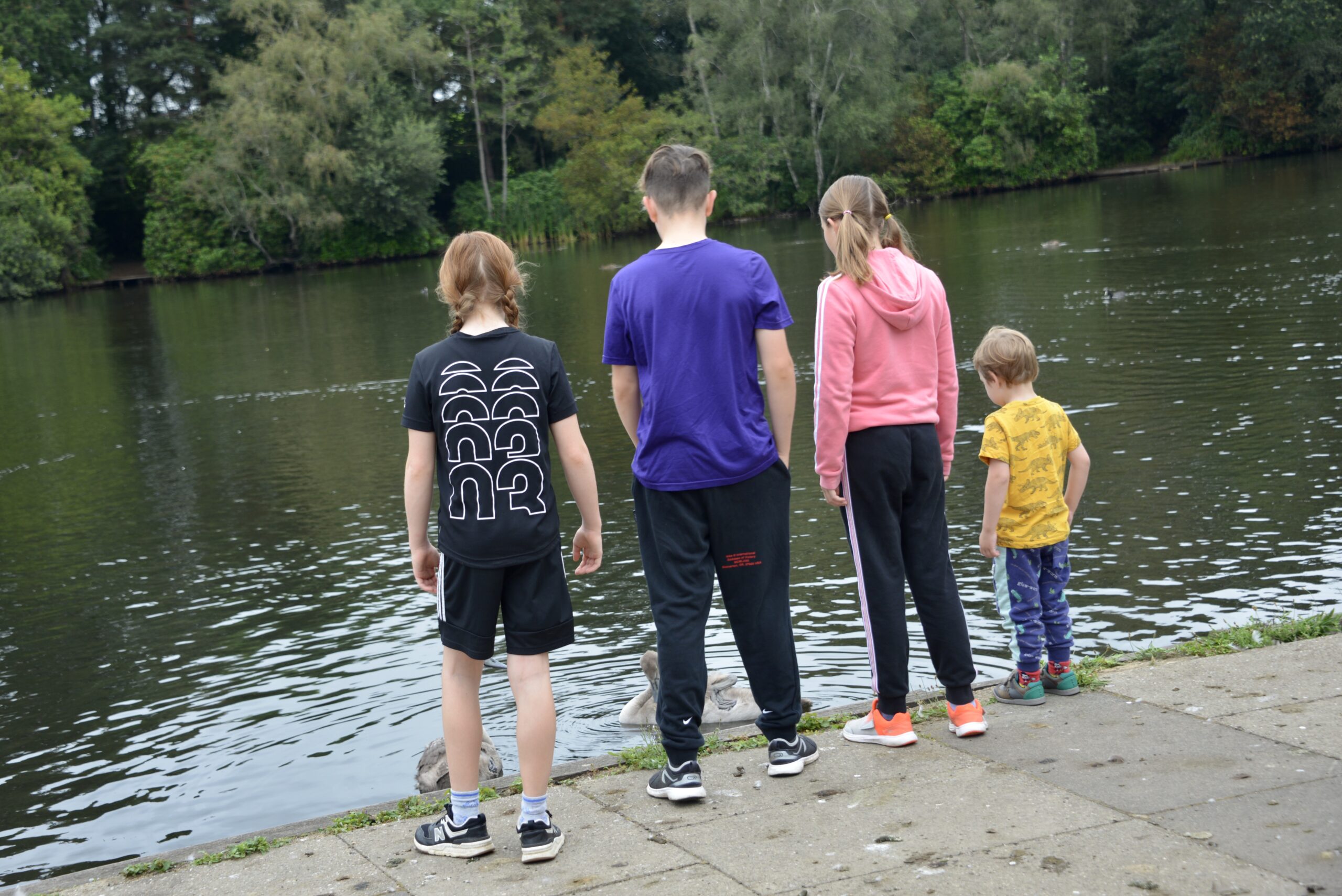 4 children looking out into a lake