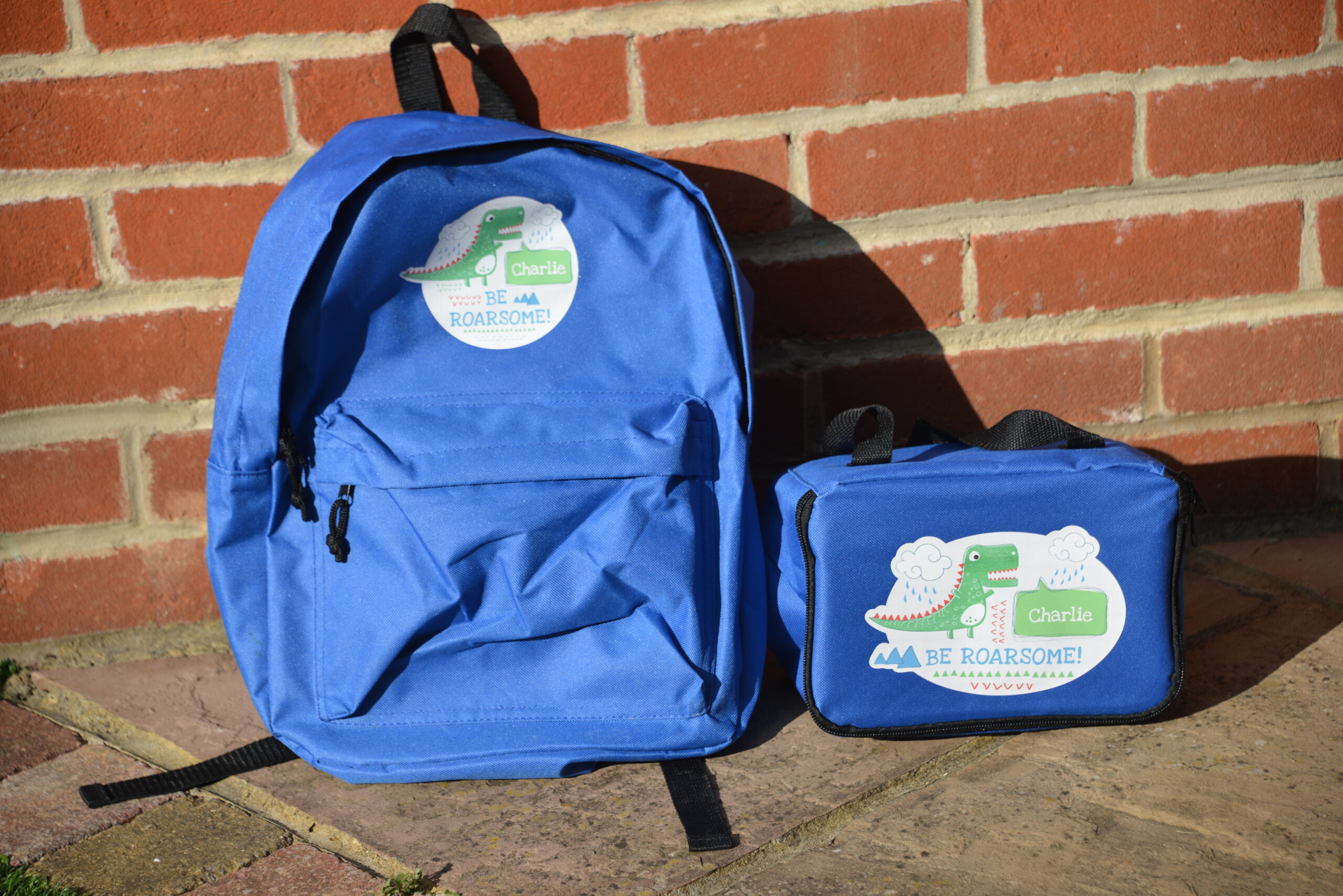 blue personalised dinosaur backpack and lunch bag