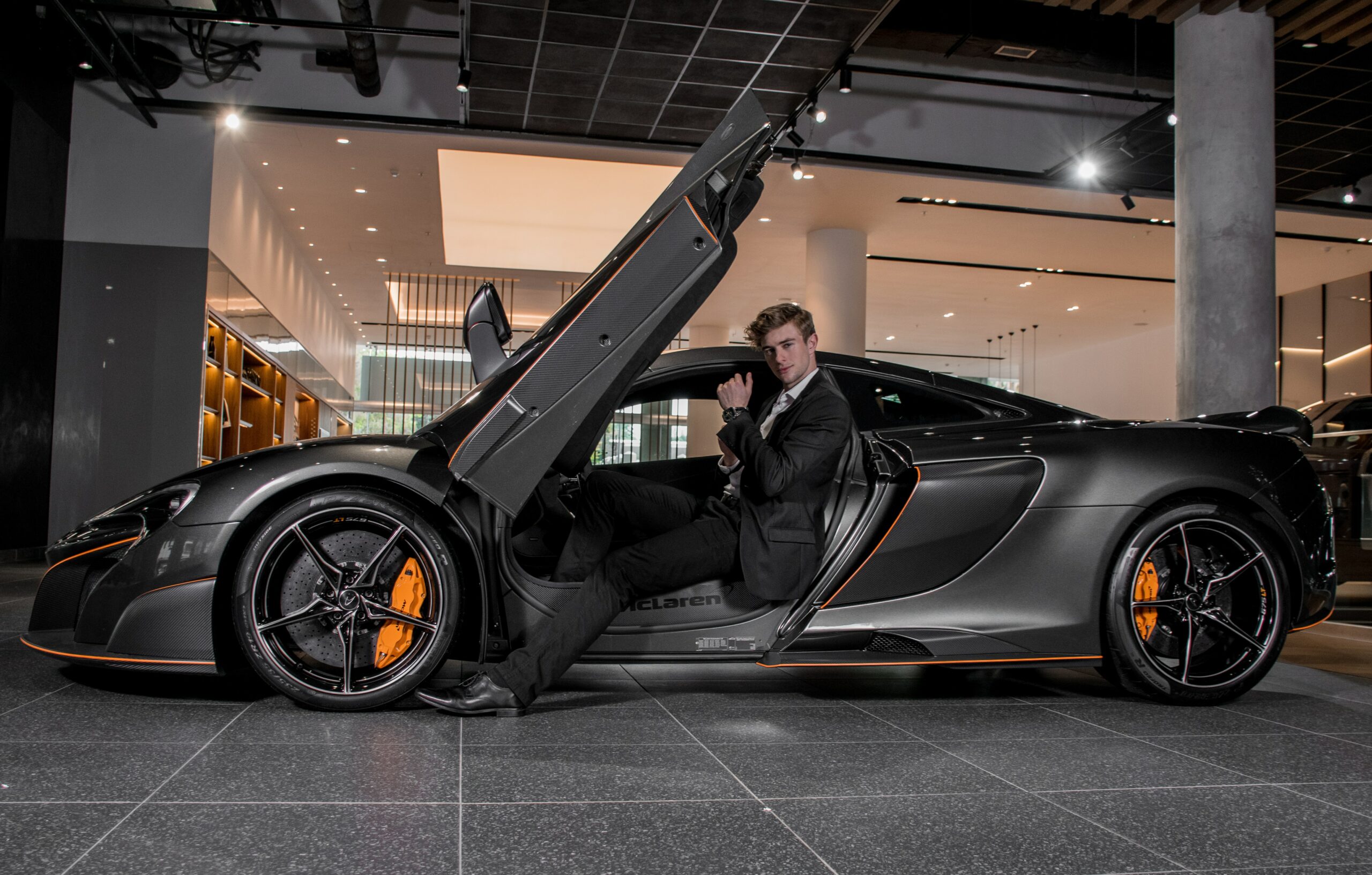 Man in black sports car