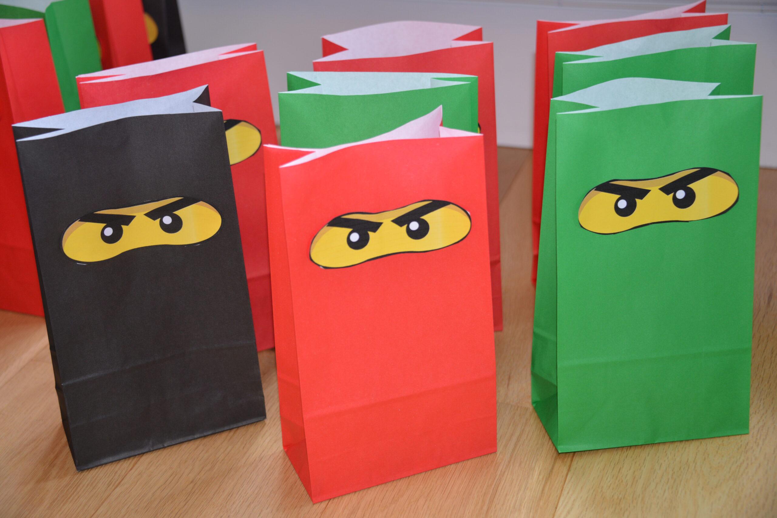 Easy Ninjago party bags using coloured paper bags and print out Ninjago eyes