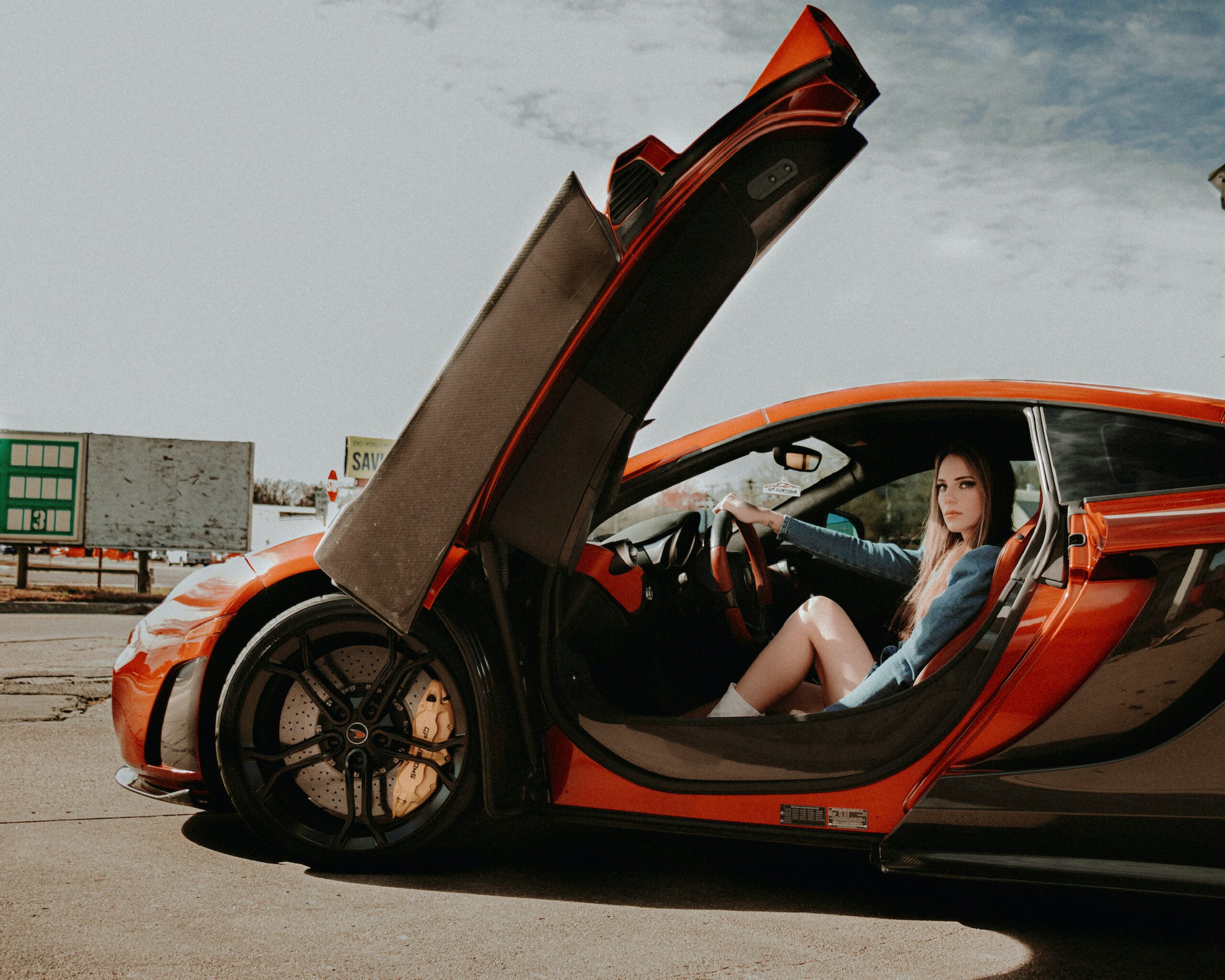 woman in red sports car