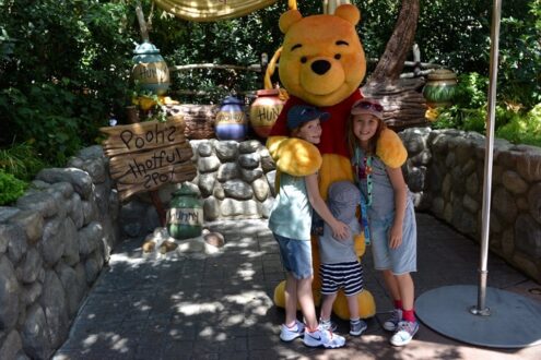 Kids with Winnie the Pooh in Disneyland