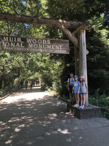 Muir Woods, children stood under the sign