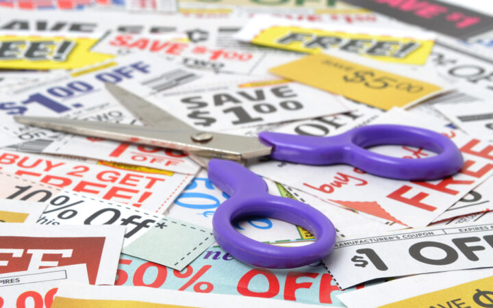 a pile fo coupons for shopping with scissors on top