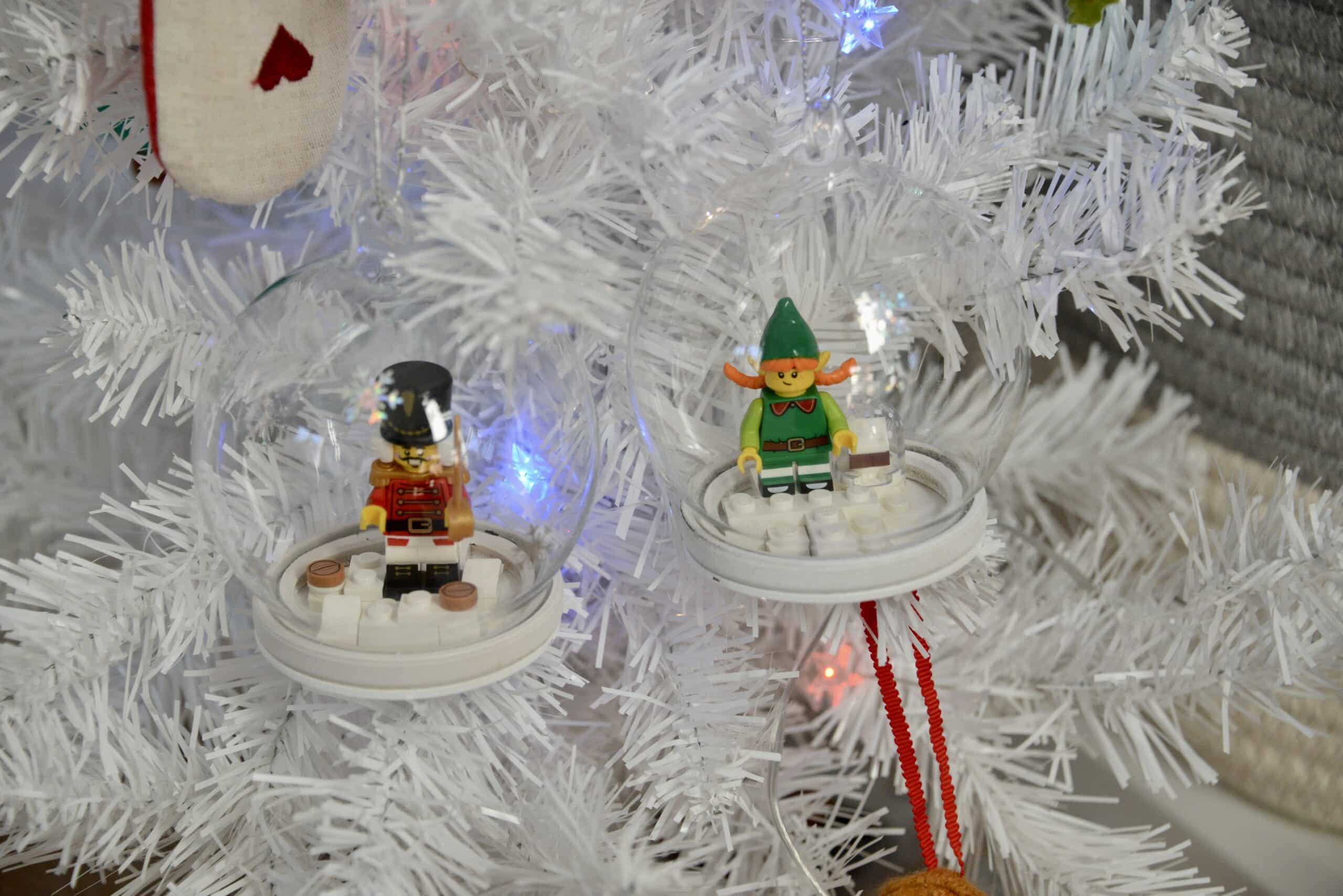 Homemade LEGO Christmas decorations for a tree. Nutcracker and elf mini figure inside a refillable snow globe tree decoration
