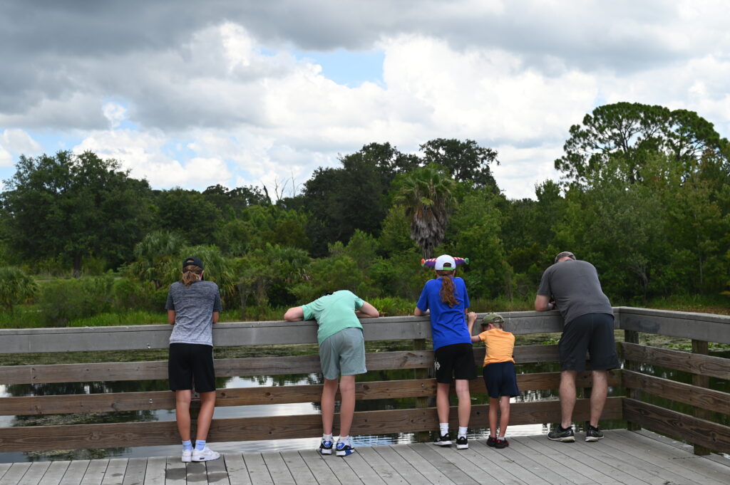 Family looking out over a river in Kapok Park