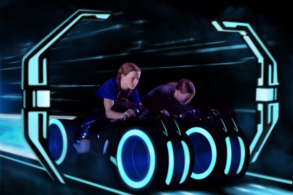 Two young girls riding TRON in Magic Kingdom, Walt Disney World, Florida