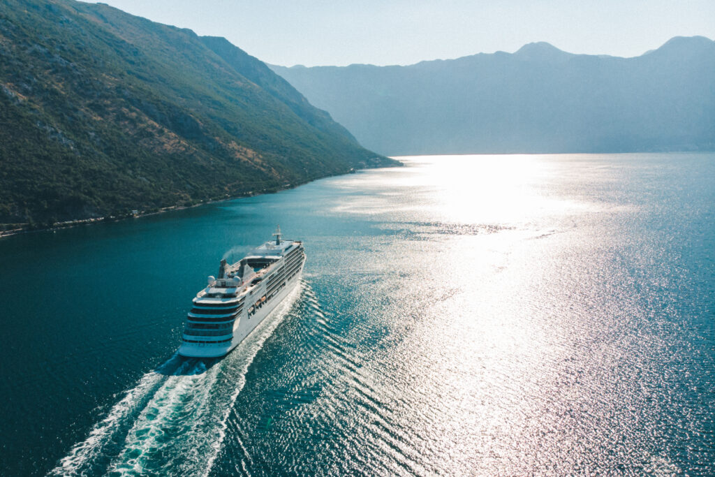 Cruise ship passing between mountains