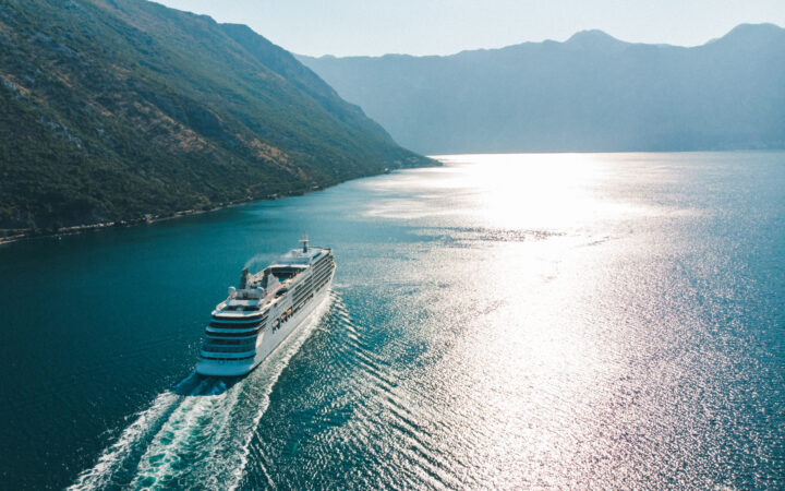 Cruise ship passing between mountains