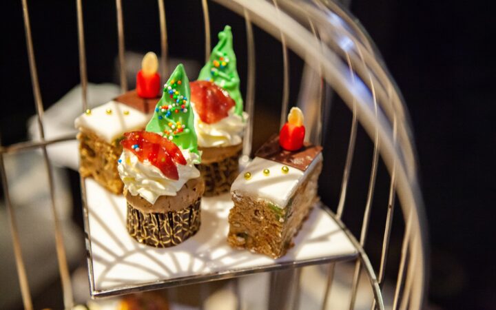 Assortment of tasty, delicious fruitcake with icing frosting decoration in Christmas theme. Perfect for afternoon tea or high tea party, Xmas, New Year celebration. Festive holiday and season greeting