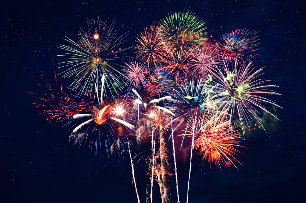 Fireworks at night over dark blue sky