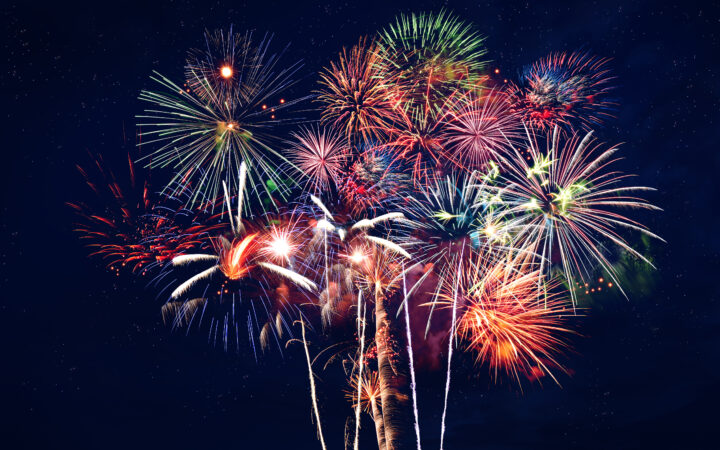 Fireworks at night over dark blue sky