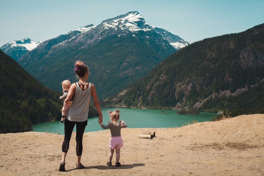 women and small children looking into a lake